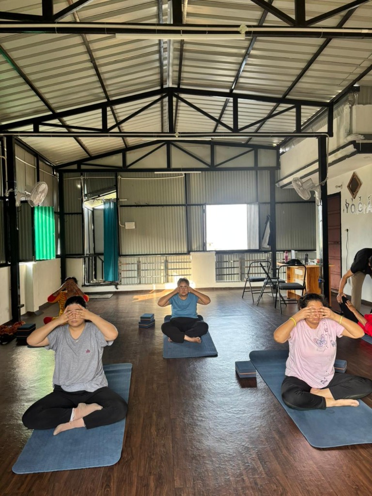 Group pranayama and meditation practice inside the studio